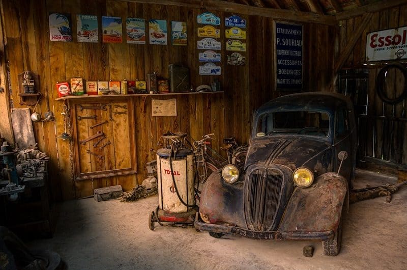 dusty antique car in a garage