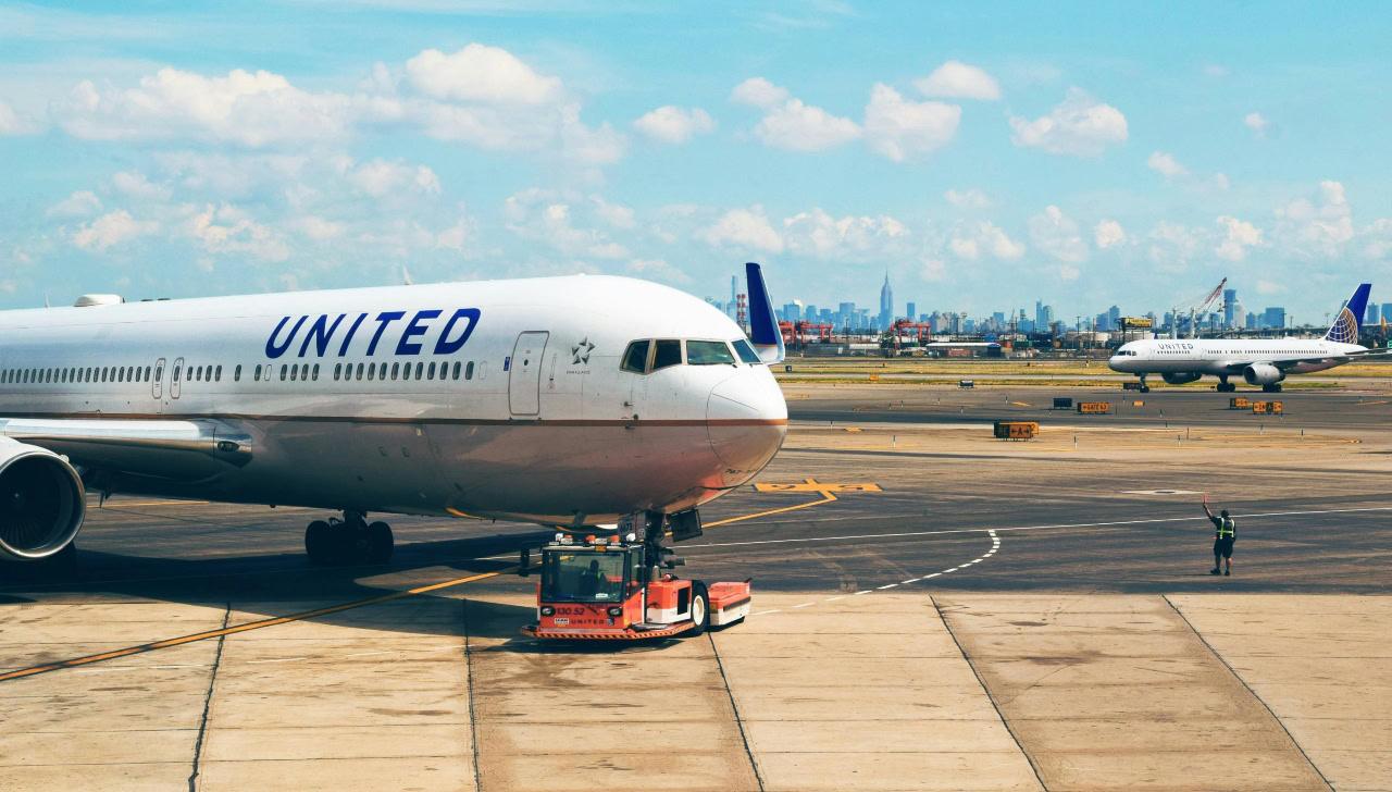 a united airlines plane pulling up to the gate